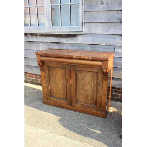 498 - A 19th century rosewood chiffonier, fitted frieze drawer over cupboard enclosed panelled doors, on b... 