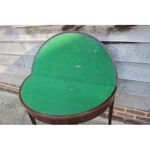 499 - A George III mahogany and banded 'D' shaped fold-over top card table, on square taper supports, 36