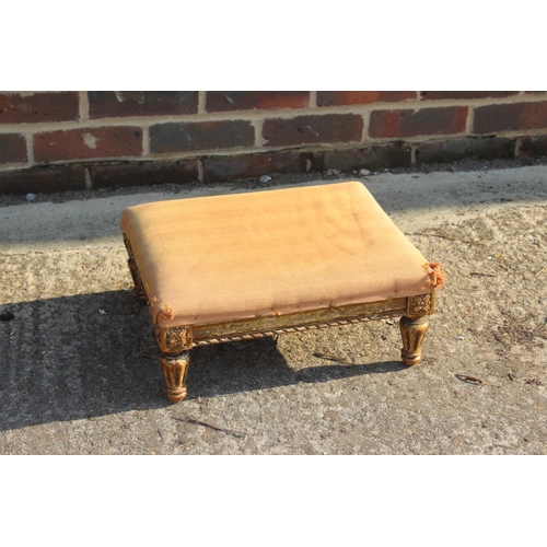 500 - A 19th century carved giltwood stool, on turned faceted supports, 16