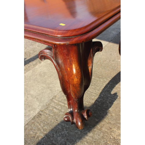 507 - A Victorian carved mahogany extending dining table with two extra leaves, on cabriole scroll support... 