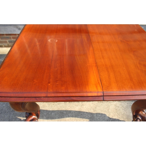 507 - A Victorian carved mahogany extending dining table with two extra leaves, on cabriole scroll support... 