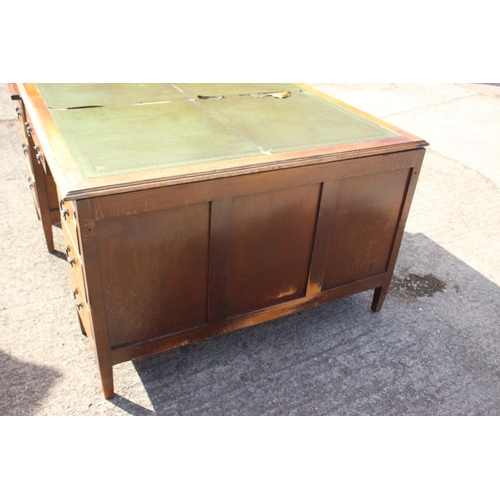 558 - A partners early 20th century walnut double pedestal desk with green leather top (for restoration), ... 