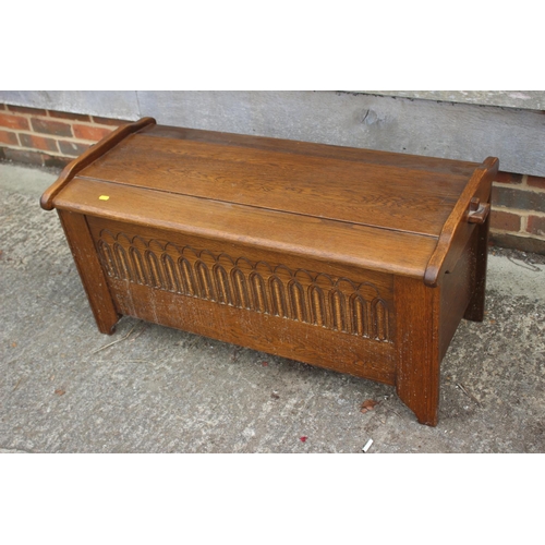 581 - An oak coffer of early 17th century design with shaped top and arcaded front, 41