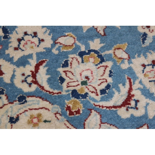 625 - A Kashan wool and part silk pile rug with star medallion and flower design on a blue ground and mult... 