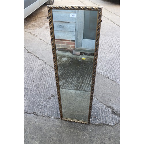 538 - A 1930s oak rectangular framed wall mirror with cut corners, plate 29