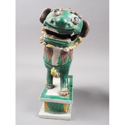 100 - A Chinese blue monochrome model of a Dog of Fo with a ball (chips), another Dog of Fo and a figure o... 