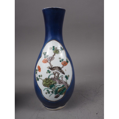 101 - A Chinese baluster vase, decorated panels with a bird in a tree and a figure in a landscape on a dar... 