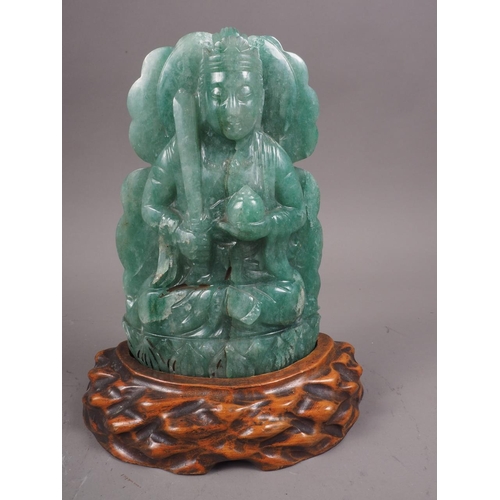 103 - A Chinese carved jade plaque of a figure with carved hardwood stand, 7 3/4