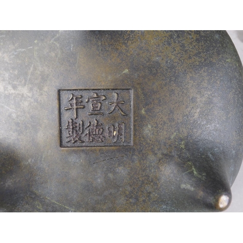 124 - A Chinese bronze censor, on three supports, six-character mark to base, 6 1/4