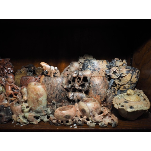 125 - A quantity of mostly Oriental soapstone and hardstone figures and brush washers