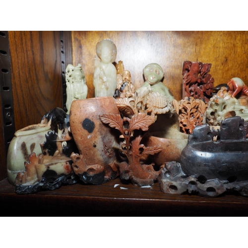 125 - A quantity of mostly Oriental soapstone and hardstone figures and brush washers