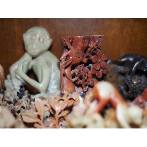 125 - A quantity of mostly Oriental soapstone and hardstone figures and brush washers