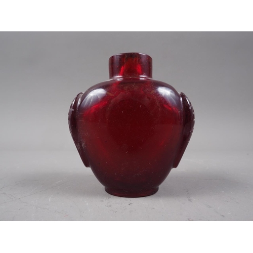 129 - A carved red Peking glass snuff bottle, 2 5/8