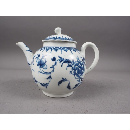 14 - A mid 18th century Worcester blue and white globular teapot and cover with hand-painted floral spray... 