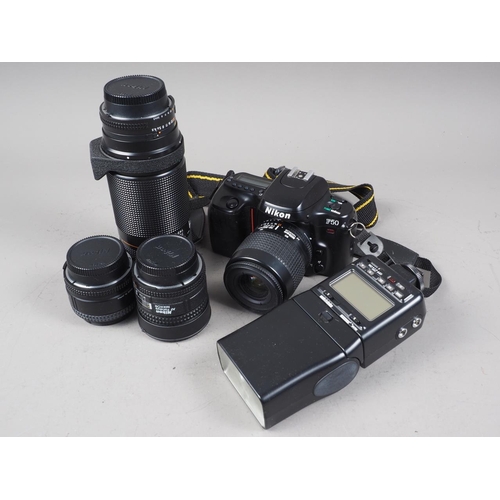 144 - A Nikon F50 camera and a number of additional lenses and accessories, in aluminium case