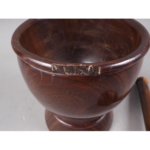 168 - An antique turned lignum vitae pestle and mortar, mortar 6 3/4