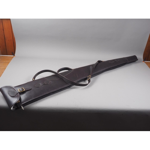 194 - A dark brown leather rifle slip with sheepskin interior, 53