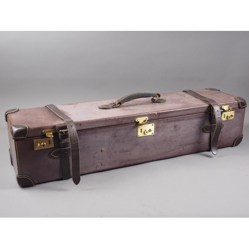 195 - A brown leather gun case with red baize interior, 34 1/4