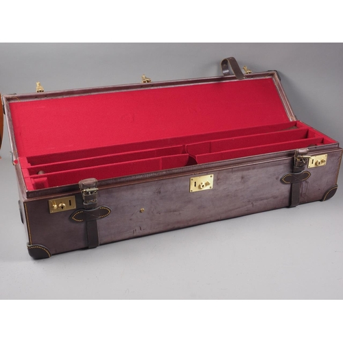 195 - A brown leather gun case with red baize interior, 34 1/4