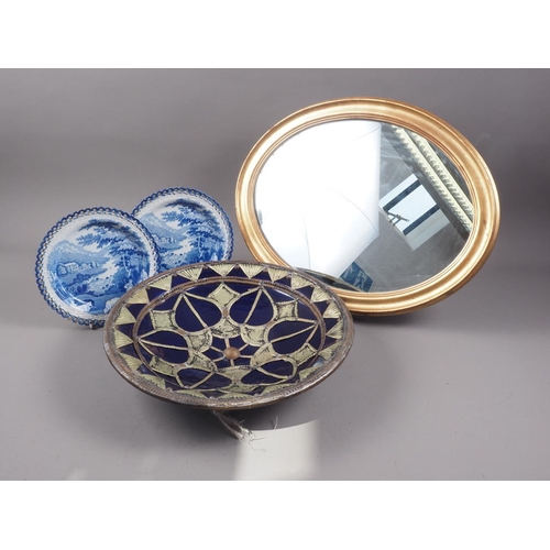 265 - A pair of 19th century blue and white decorated ribbon plates, an Eastern pottery charger with metal... 