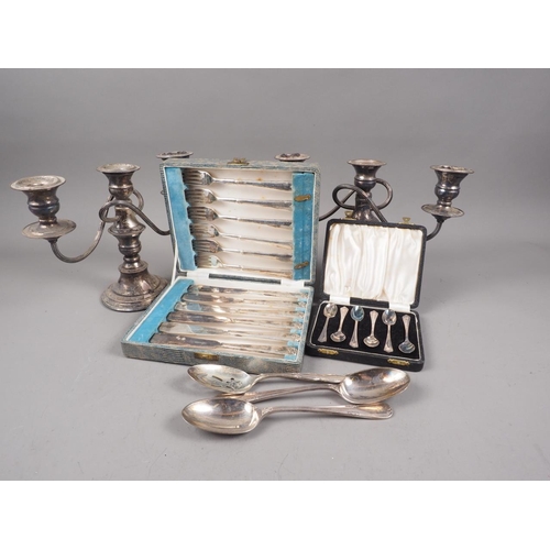 308 - A pair of silver plated three-branch candelabra, two cased sets of plated cutlery and three plated s... 