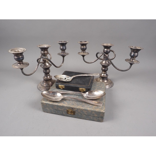 308 - A pair of silver plated three-branch candelabra, two cased sets of plated cutlery and three plated s... 