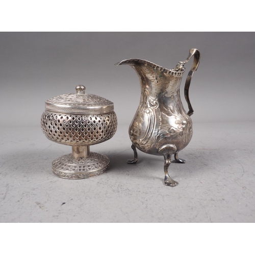 330 - A Georgian silver cream jug with embossed decoration, 2oz troy approx, and a Middle Eastern pedestal... 