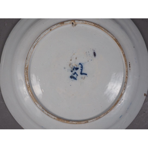 41 - An 18th century Delft shallow bowl with vase of flowers decoration, 12