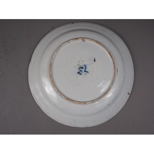 41 - An 18th century Delft shallow bowl with vase of flowers decoration, 12