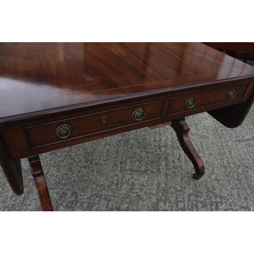 476 - An early 19th century mahogany and banded sofa table, fitted two drawers with brass ring handles, on... 