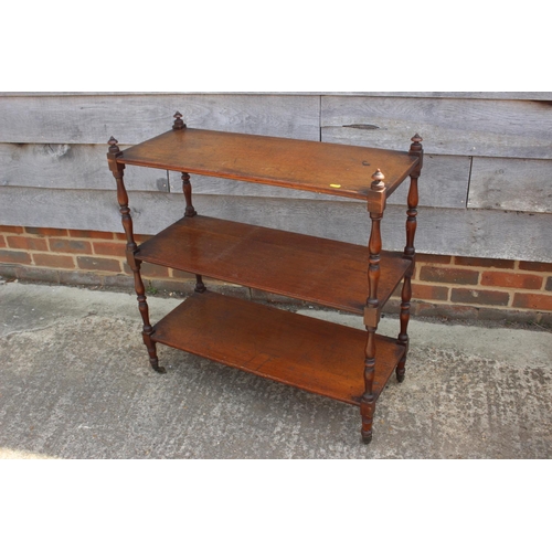 488 - A 19th century mahogany three-tier whatnot, on turned supports and brass castors, 31