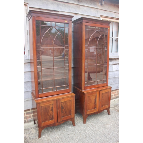 520 - A pair of George III figured mahogany display cabinets enclosed Gothic lattice glazed panel doors ov... 