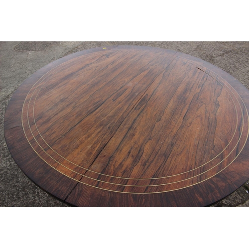 521 - A Regency/William IV rosewood and banded brass inlaid circular top table, on turned column and tripo... 