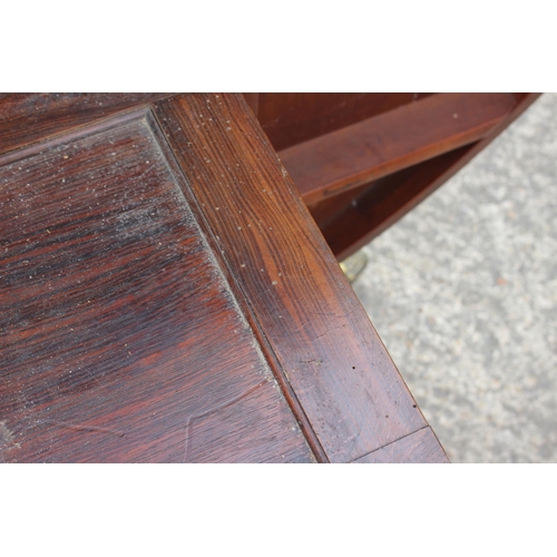 521 - A Regency/William IV rosewood and banded brass inlaid circular top table, on turned column and tripo... 