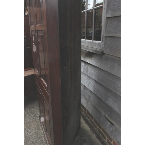 525 - An 18th century provincial oak corner cupboard, the shaped interior enclosed two arch top doors over... 