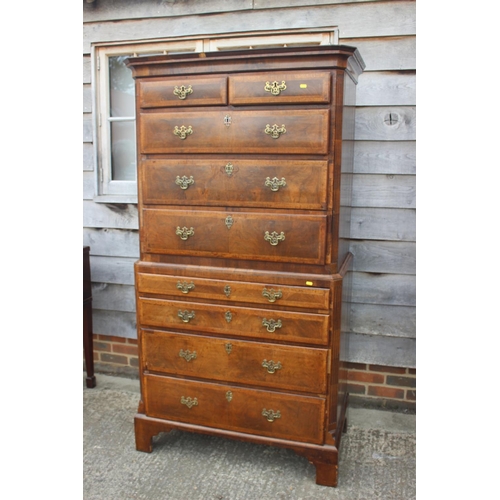 526 - An early 18th century figured walnut and feather banded chest on chest, the upper section fitted two... 