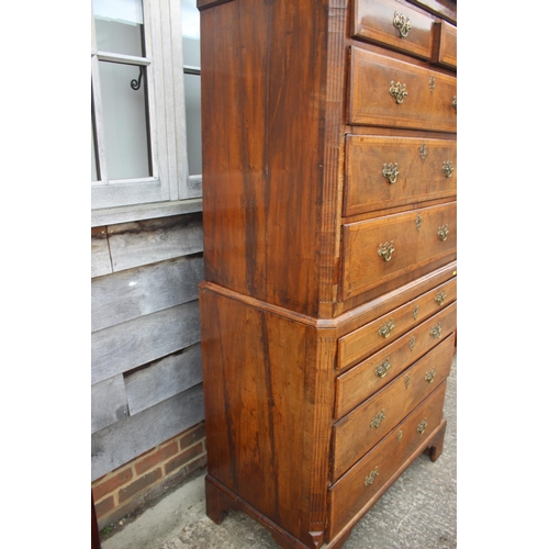 526 - An early 18th century figured walnut and feather banded chest on chest, the upper section fitted two... 