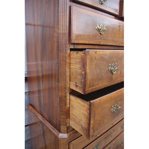 526 - An early 18th century figured walnut and feather banded chest on chest, the upper section fitted two... 