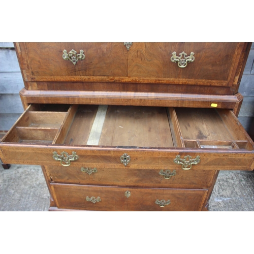 526 - An early 18th century figured walnut and feather banded chest on chest, the upper section fitted two... 