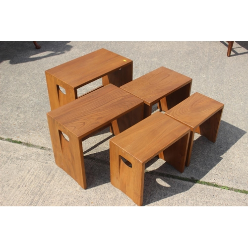 547 - An Ercol nest of five carved elm occasional tables, on panel end supports, 20