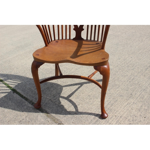 553 - A Stewart Linford yew Windsor elbow chair with pierced splat and crinoline stretcher, on turned supp... 