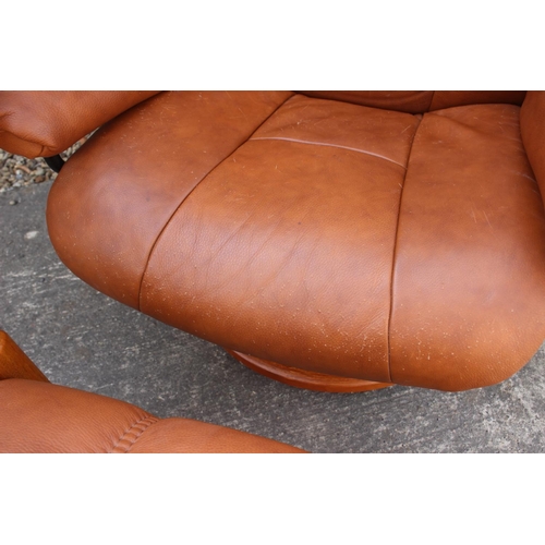 554 - An Ekorns tan leather stressless recliner armchair and matching stool