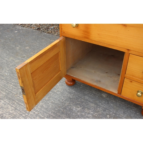 613 - An 18th century Oregon pine chest, fitted four graduated drawers over two small drawers and cupboard... 