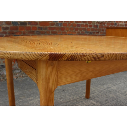 615 - A 1960s  Ercol pine oval extending dining table, on turned support, 54