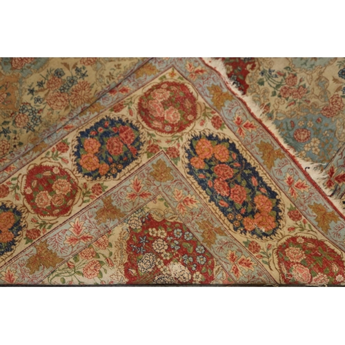 635 - A Persian city rug with all-over floral design on a light blue ground, 122