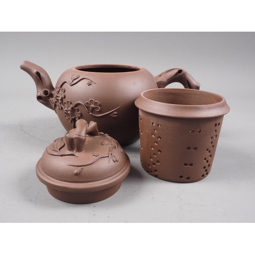 97 - A Chinese Yixing teapot with relief floral decoration, 4 1/4