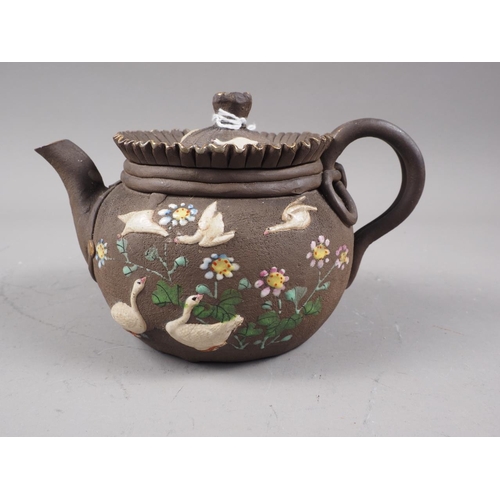 97 - A Chinese Yixing teapot with relief floral decoration, 4 1/4