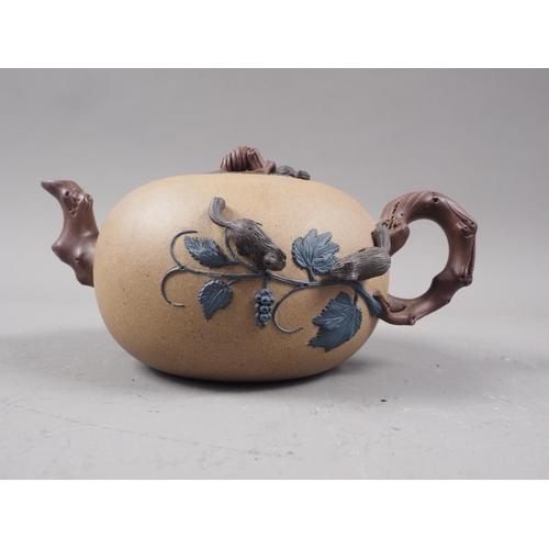 97 - A Chinese Yixing teapot with relief floral decoration, 4 1/4