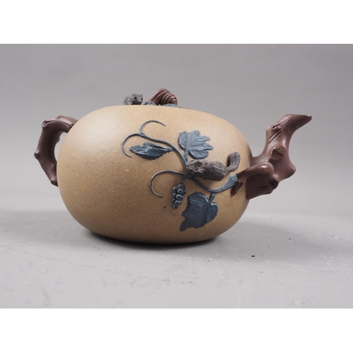 97 - A Chinese Yixing teapot with relief floral decoration, 4 1/4