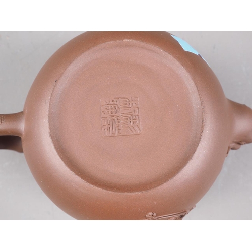 97 - A Chinese Yixing teapot with relief floral decoration, 4 1/4